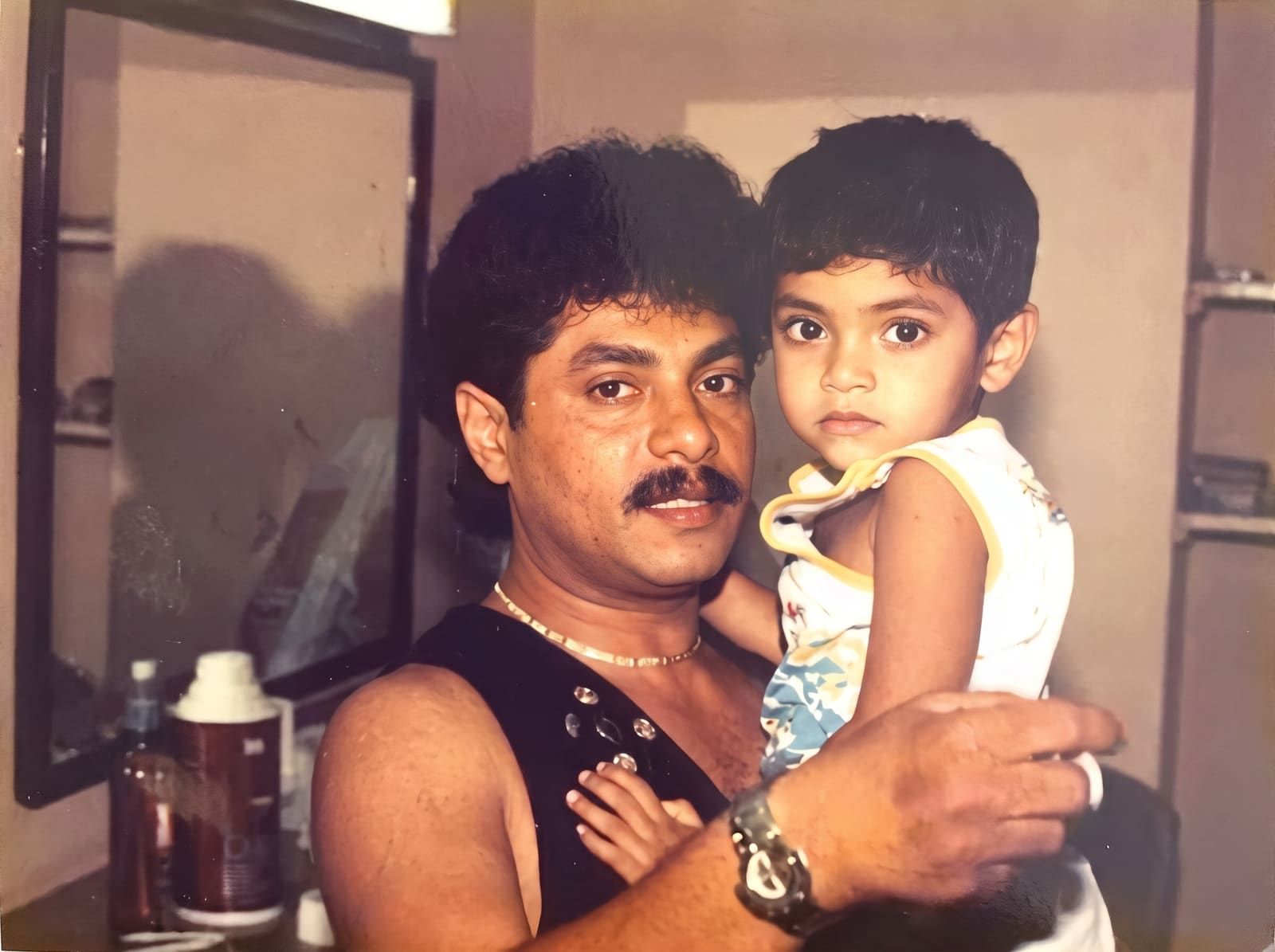 Rookantha holding daughter Raini Charuka backstage before a major concert performance.
